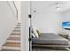A bright bedroom with wooden floors and stairs plus a modern ceiling fan at , Atlanta, GA 30315