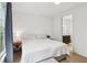 A bright bedroom with hardwood floors, a big window, and a view into the bathroom with modern fixtures at , Atlanta, GA 30315