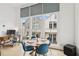 Bright dining area with large windows, modern table set, and a dedicated workspace for a comfortable and stylish living at , Atlanta, GA 30315