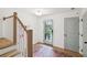 Bright foyer featuring wood floors, natural light, and stairs with a white banister at , Atlanta, GA 30315