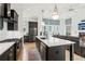 Open concept kitchen and living room with a large island, stainless appliances, and modern lighting at , Atlanta, GA 30315