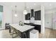 Sleek kitchen with black cabinetry, stainless appliances, quartz counters, and bar stool seating at , Atlanta, GA 30315