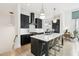 Modern kitchen featuring a large island, black cabinets, and stainless appliances with eat in dining at , Atlanta, GA 30315