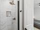 Modern walk-in shower featuring marble tile and a bronze shower head and fixtures at , Atlanta, GA 30315