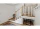 Staircase with white railing, wood treads, and space for pet area beneath the stairs at , Atlanta, GA 30315