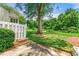 A backyard featuring a large tree, a white fence, and a view of the forest at 1003 Cannongate Sw Xing, Marietta, GA 30064