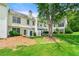Exterior view of home, showcasing backyard, green grass, and lush trees on a sunny day at 1003 Cannongate Sw Xing, Marietta, GA 30064