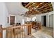 Spacious living area with a fireplace, exposed ceiling, and stairs, presenting an opportunity for renovation and design at 1003 Cannongate Sw Xing, Marietta, GA 30064