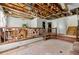 Open living area with exposed ceiling, stairs, and partial furniture, ripe for a complete renovation and personalized touch at 1003 Cannongate Sw Xing, Marietta, GA 30064