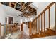 Renovation opportunity: Spacious living area with stairs and exposed ceiling beams, awaiting restoration and customization at 1003 Cannongate Sw Xing, Marietta, GA 30064