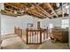 Open-concept living room with exposed ceiling beams, a fireplace, and stairs, awaiting a comprehensive renovation and transformation at 1003 Cannongate Sw Xing, Marietta, GA 30064