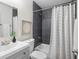 Modern bathroom showcasing sleek gray tiling in the shower, elegant vanity and framed art at 1258 Campbellton Sw Rd, Atlanta, GA 30310