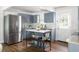 Modern kitchen featuring stainless steel appliances, an island with marble countertop, and custom cabinetry at 1258 Campbellton Sw Rd, Atlanta, GA 30310