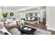 Open-concept living room with hardwood floors, bright windows, and seamless access to dining and kitchen at 1258 Campbellton Sw Rd, Atlanta, GA 30310