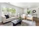 Cozy living room featuring a large window, plush seating, and stylish decor at 1258 Campbellton Sw Rd, Atlanta, GA 30310