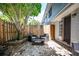 Backyard with seating area, mature tree, stone ground and brick siding at 136 Peachtree Memorial Nw Dr # Pa4, Atlanta, GA 30309