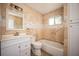 This bathroom boasts tile walls, a shower-tub combo, and a white vanity at 136 Peachtree Memorial Nw Dr # Pa4, Atlanta, GA 30309