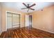 This bedroom features wood floors, tan walls, and a ceiling fan with lights at 136 Peachtree Memorial Nw Dr # Pa4, Atlanta, GA 30309