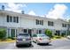Exterior view of a two-story townhome with black shutters and well-manicured landscaping at 136 Peachtree Memorial Nw Dr # Pa4, Atlanta, GA 30309