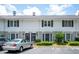 Exterior view of a two-story townhome with black shutters and well-manicured landscaping at 136 Peachtree Memorial Nw Dr # Pa4, Atlanta, GA 30309
