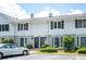 Exterior view of a two-story townhome with black shutters and well-manicured landscaping at 136 Peachtree Memorial Nw Dr # Pa4, Atlanta, GA 30309