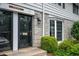 Close up exterior view of the townhome entrance featuring black door and stone accents at 136 Peachtree Memorial Nw Dr # Pa4, Atlanta, GA 30309