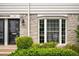 Close up exterior view of the townhome entrance featuring black door and bay window at 136 Peachtree Memorial Nw Dr # Pa4, Atlanta, GA 30309