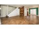 Open-concept living room with white staircase, wood accent wall, and hardwood floors at 136 Peachtree Memorial Nw Dr # Pa4, Atlanta, GA 30309