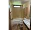 Bathroom featuring a shower-tub combo and a wood vanity with a sink and a tiled shower and floors at 1631 Billy Bullock Rd, Dallas, GA 30157