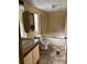 Bathroom featuring a shower-tub combo and a wood vanity with a sink and a tiled shower and floors at 1631 Billy Bullock Rd, Dallas, GA 30157