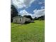 Front yard featuring large grassy area with mature trees and a home with neutral siding at 1631 Billy Bullock Rd, Dallas, GA 30157