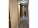 Hallway with wood-look flooring, neutral walls, and a view into other rooms at 1631 Billy Bullock Rd, Dallas, GA 30157