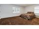 Spacious bedroom with neutral walls, carpeted floors, and natural light from the windows at 223 Dogwood Ln, Lawrenceville, GA 30046