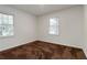 This bedroom offers neutral colors and natural light from two windows at 223 Dogwood Ln, Lawrenceville, GA 30046