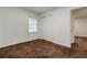This bedroom offers carpeting, a closet, and natural light at 223 Dogwood Ln, Lawrenceville, GA 30046