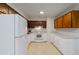 Functional kitchen featuring white appliances, ample countertop space, and classic wood cabinets at 223 Dogwood Ln, Lawrenceville, GA 30046