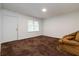 Cozy living room with plush carpeting, neutral walls, and a comfortable seating area at 223 Dogwood Ln, Lawrenceville, GA 30046
