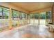 Enclosed back porch featuring screens, concrete floor and view of trees at 223 Dogwood Ln, Lawrenceville, GA 30046