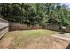 Spacious, fenced backyard with a grill and a concrete patio area at 2780 Lakeview Walk, Decatur, GA 30035