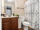 Bathroom featuring a dark vanity, patterned shower curtain, and ample storage at 2780 Lakeview Walk, Decatur, GA 30035