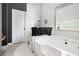 In-progress bathroom with modern white bathtub, and updated white-tiled walls at 2780 Lakeview Walk, Decatur, GA 30035