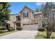 Charming two-story home featuring a stone front, attached two car garage and well-manicured lawn at 2780 Lakeview Walk, Decatur, GA 30035