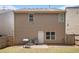 Back exterior view of the home featuring brown siding, a small patio, and backyard at 2780 Lakeview Walk, Decatur, GA 30035