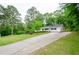 Well-maintained home with a long driveway and lush landscaping at 2923 Bicentennial Dr, Stone Mountain, GA 30087