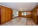 Spacious living room featuring paneled walls, wood flooring and a ceiling fan at 2923 Bicentennial Dr, Stone Mountain, GA 30087