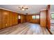 Spacious living room showcasing paneled walls, wood flooring and a ceiling fan at 2923 Bicentennial Dr, Stone Mountain, GA 30087