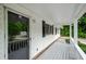 Relaxing porch with wood flooring and fresh, white paint and black shutters at 2923 Bicentennial Dr, Stone Mountain, GA 30087