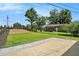View of backyard with lush lawn, privacy fence, patio, and mature trees at 4020 Ester Sw Dr, Atlanta, GA 30331