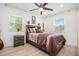 Cozy bedroom features two windows, a ceiling fan, and neutral decor throughout at 4020 Ester Sw Dr, Atlanta, GA 30331