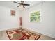 Well-lit bedroom featuring a ceiling fan and area rug at 4020 Ester Sw Dr, Atlanta, GA 30331